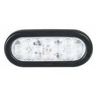 This LED backup/reverse light features a clear oval lens and grommet mount for permanent installation. It connects via a wire harness and complies with SAE J1398. Typical applications include providing rearward illumination on vehicles and equipment during reversing maneuvers