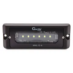 This MAXXIMA LED floodlight is designed for permanent surface-mount installation on vehicles. It features a black rectangular housing, a bracket for universal mounting, and wire leads for electrical connection. The flood beam pattern provides area illumination for tasks such as loading, repair, or equipment inspection.