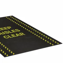 This polypropylene entrance mat with adhesive backing measures 3 ft x 5 ft and is 1/8 in thick. It is designed to mark safe walkways and reduce trip hazards in industrial environments such as warehouses, factories, and workshops.