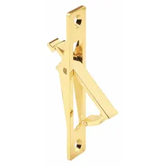 This pocket door folding pull handle is made of steel with a polished brass finish. It features a lever design with a 0.25 in flat profile and a 3.5 in overall length. The handle mounts via threaded holes, suitable for sliding doors in interior applications where a low-profile grip is needed.