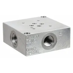 This valve subplate is designed for mounting D03 NFPA size hydraulic valves. It features a ductile iron body and side porting for fluid routing in hydraulic systems. Overall height is 3.5 inches.