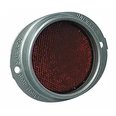 Red round stick-on reflector with acrylic lens, measuring 4-11/16 in overall length and 3/4 in overall width. Meets SAE A standards for reflector performance. Used for vehicle conspicuity and safety marking on trailers, trucks, and other equipment requiring compliant side or rear reflectors.
