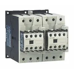 Reversing IEC contactor with 3 poles, 3 normally open (3NO) contacts, rated 40 A, and a 24V AC coil. Includes integrated surge suppression. Used for controlling three-phase motors in forward and reverse directions in applications such as conveyors, hoists, and pumps.