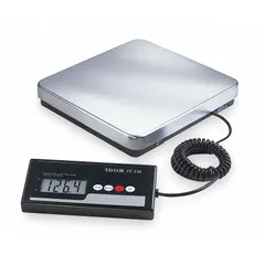 The TAYLOR TE150 is a bench scale with a corded remote indicator, featuring a 12 in x 12 1/4 in stainless steel weighing surface. Readability is 0.1 kg/0.2 lb. Not IP rated, intended for indoor dry environments. Suitable for general weighing tasks such as portioning, checkweighing, and inventory counting.