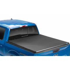 This folding tonneau cover from LUND is constructed of black vinyl and measures 73 3/4 inches long by 30 1/2 inches wide. It features a bolt-on mounting type for secure attachment to the truck bed. Designed to protect cargo from weather and theft, it is suitable for trucks with corresponding bed dimensions.