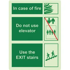 This adhesive-mount plastic sign (12 in x 9 in) displays 'In Case of Fire, Do Not Use Elevator, Use the Exit Stairs.' It glows in the dark to remain visible during power loss, aiding egress in commercial and industrial facilities. Not retroreflective. Part number 4240-00-NIB-0305.