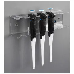 Wall-mounted pipette holder made of clear PETG. Overall width 12 5/8 in, height 3 3/4 in, length 2 1/2 in. Holds up to six pipettes for organized storage and easy access in laboratory settings.