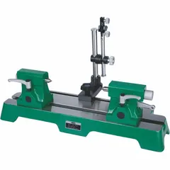Horizontal bench center with guide surface for precision inspection of cylindrical workpieces. Working diameter 10 15/64 in, maximum working length 15 47/64 in. Used for checking concentricity, runout, and alignment in machining and quality control.